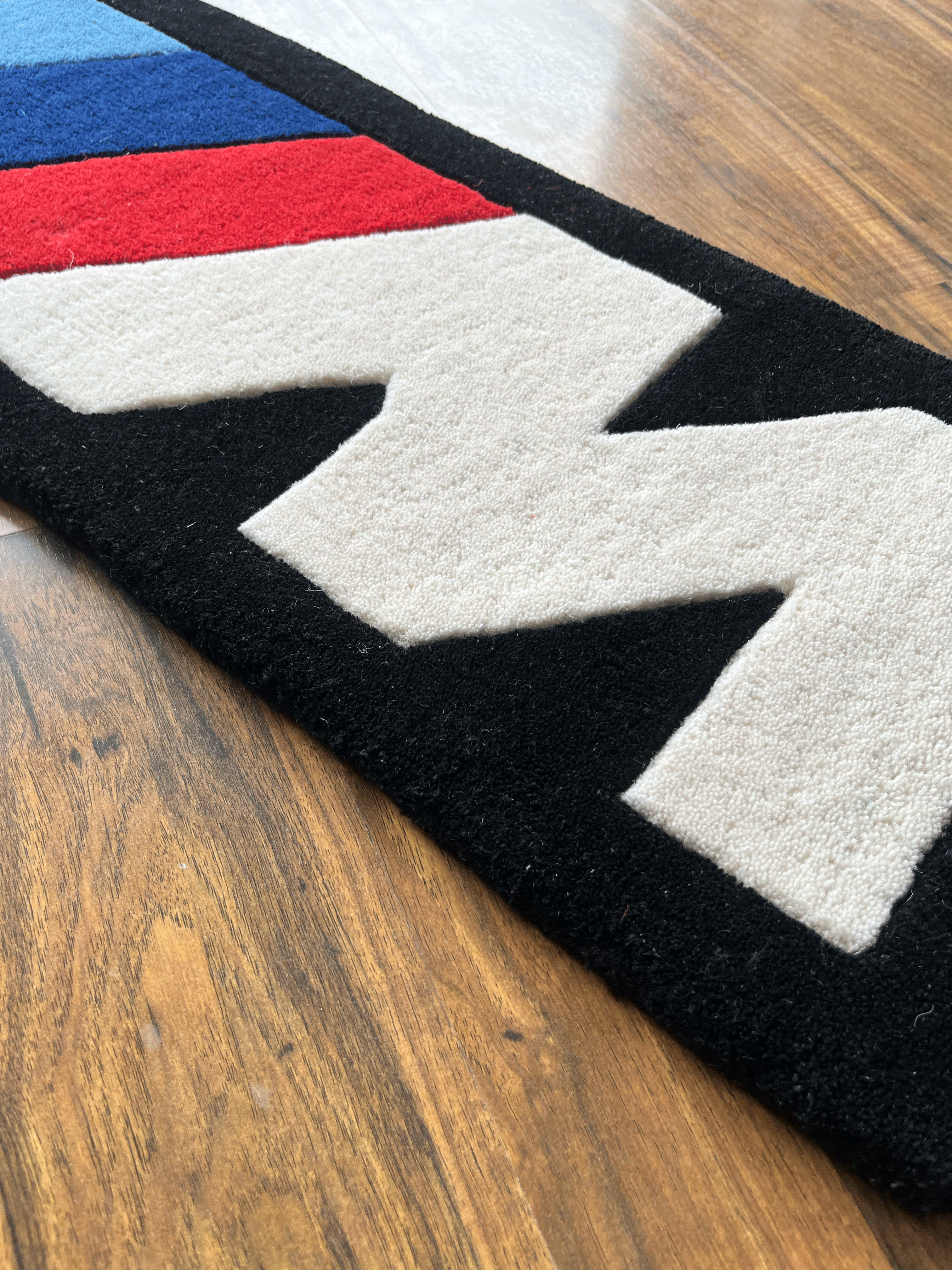 M speed  racing Rug by The Drip Co.